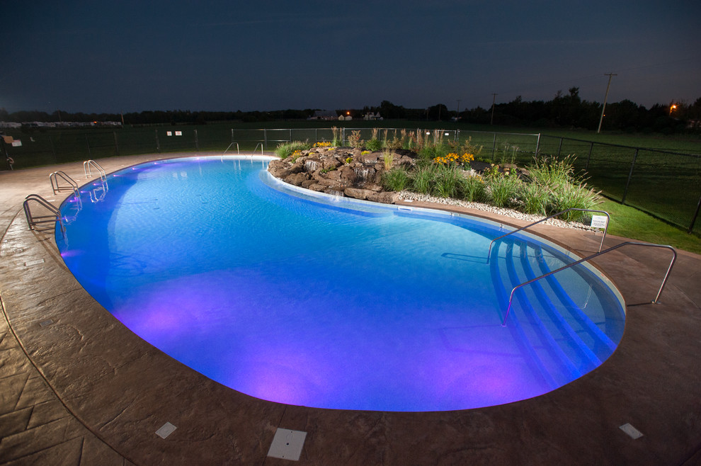 Pool fountain - huge rustic courtyard stamped concrete and freeform natural pool fountain idea