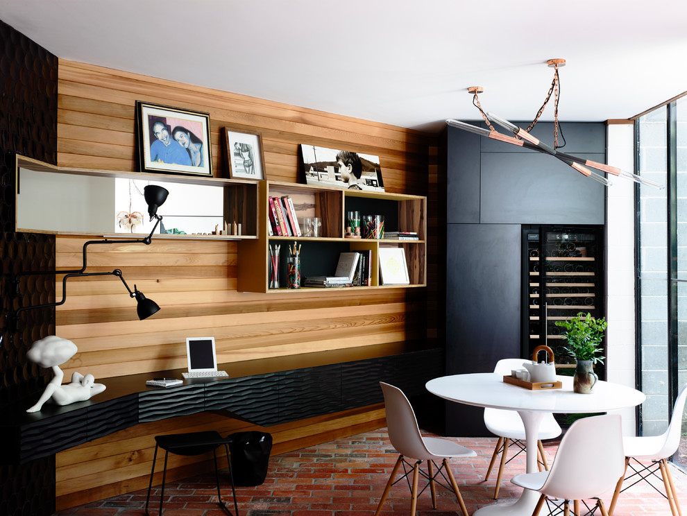 This is an example of a mid-sized eclectic kitchen/dining combo in Melbourne with black walls and brick floors.
