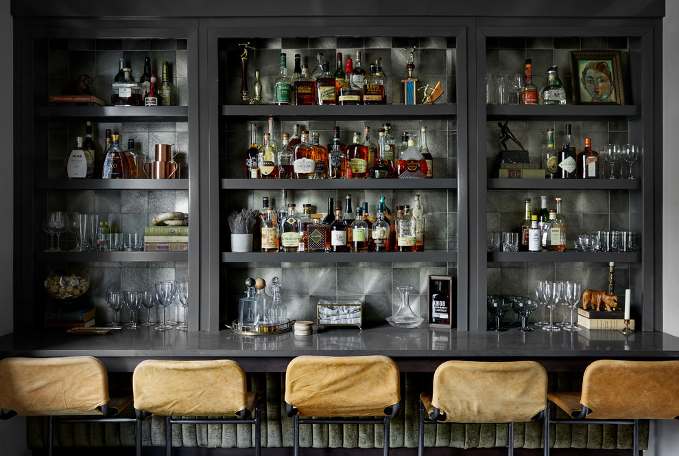This is an example of a small transitional single-wall seated home bar in Nashville with open cabinets, grey cabinets, quartz benchtops, grey splashback, dark hardwood floors, grey benchtop and metal splashback.