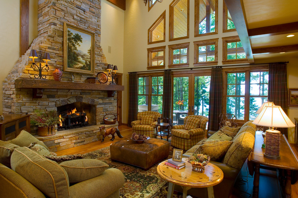 Traditional formal open concept living room in Minneapolis with beige walls, medium hardwood floors and a stone fireplace surround.
