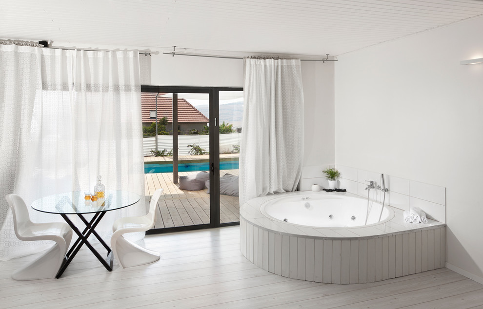 Inspiration for a modern bathroom in Other with a hot tub.