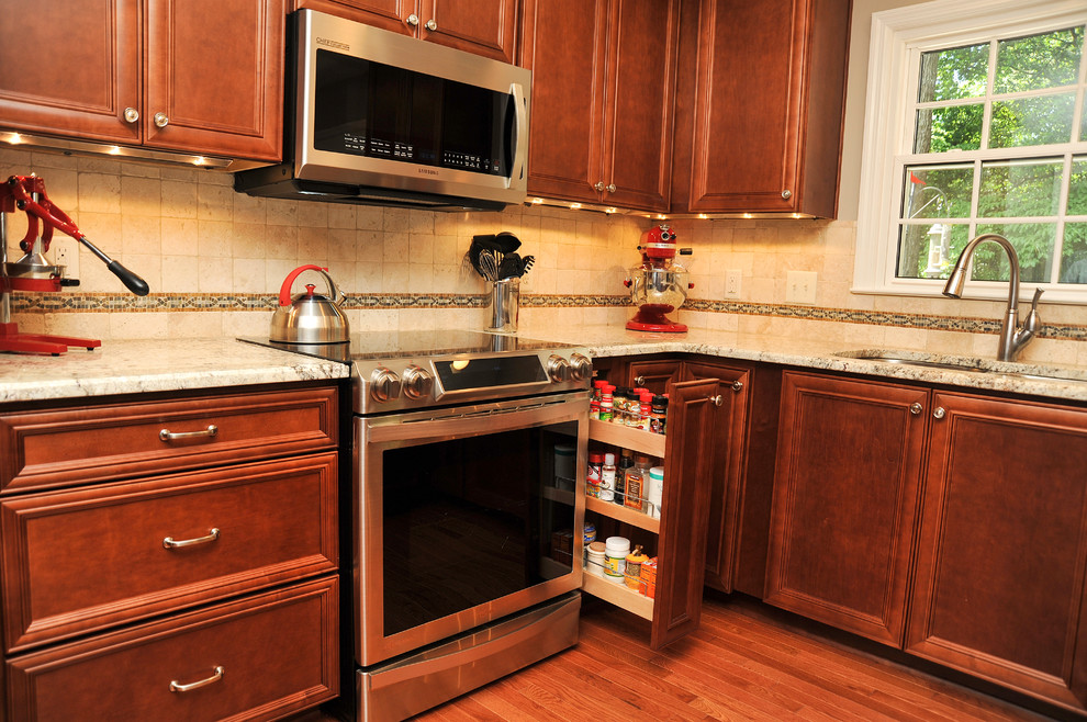 Mid-sized transitional u-shaped medium tone wood floor eat-in kitchen photo in Birmingham with a double-bowl sink, flat-panel cabinets, medium tone wood cabinets, granite countertops, beige backsplash, stone tile backsplash, stainless steel appliances and a peninsula
