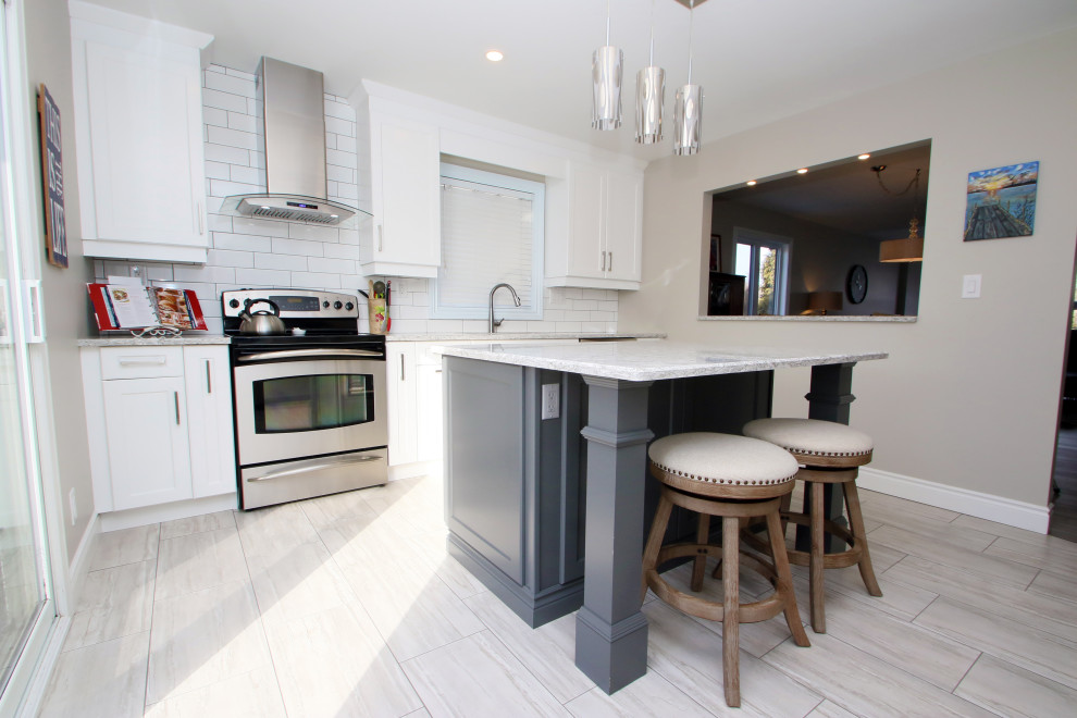 Eat-in kitchen - mid-sized transitional galley porcelain tile and gray floor eat-in kitchen idea with a double-bowl sink, shaker cabinets, white cabinets, granite countertops, white backsplash, subway tile backsplash, stainless steel appliances, no island and gray countertops