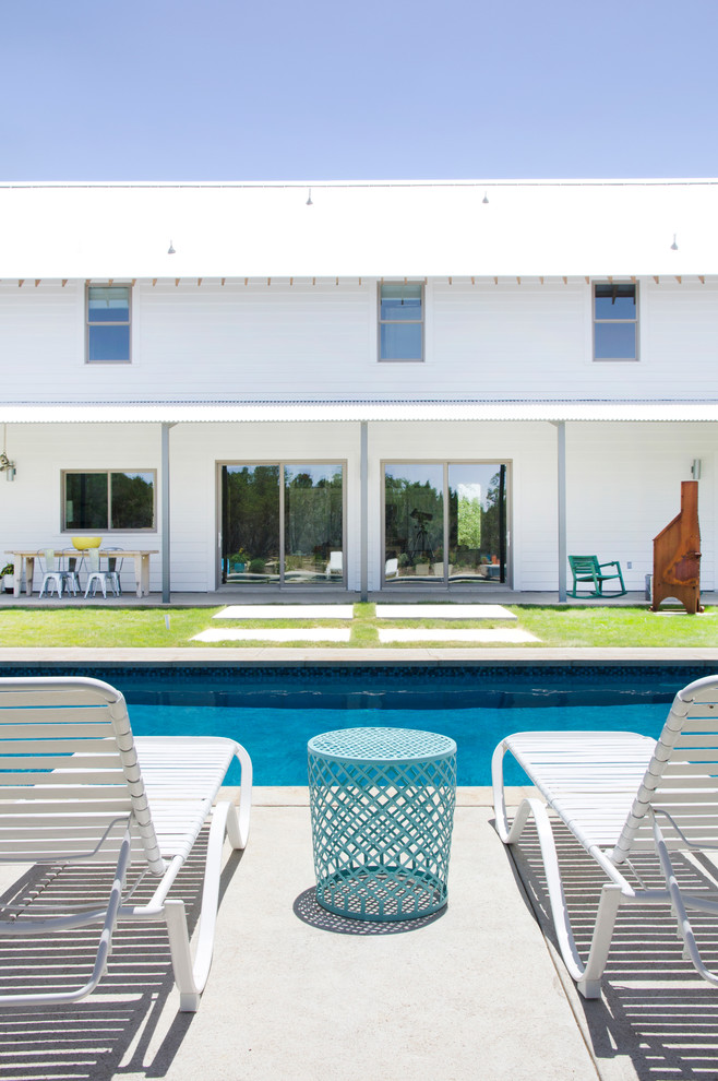 This is an example of a country rectangular pool in Austin with concrete slab.