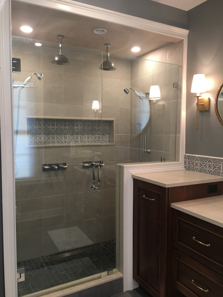 Mid-sized transitional master gray tile and ceramic tile cement tile floor, gray floor and single-sink double shower photo in Boston with recessed-panel cabinets, dark wood cabinets, gray walls, quartz countertops, a hinged shower door, beige countertops and a built-in vanity