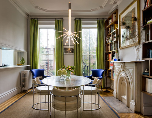 dining room with layered shades and green drapery fabrics 