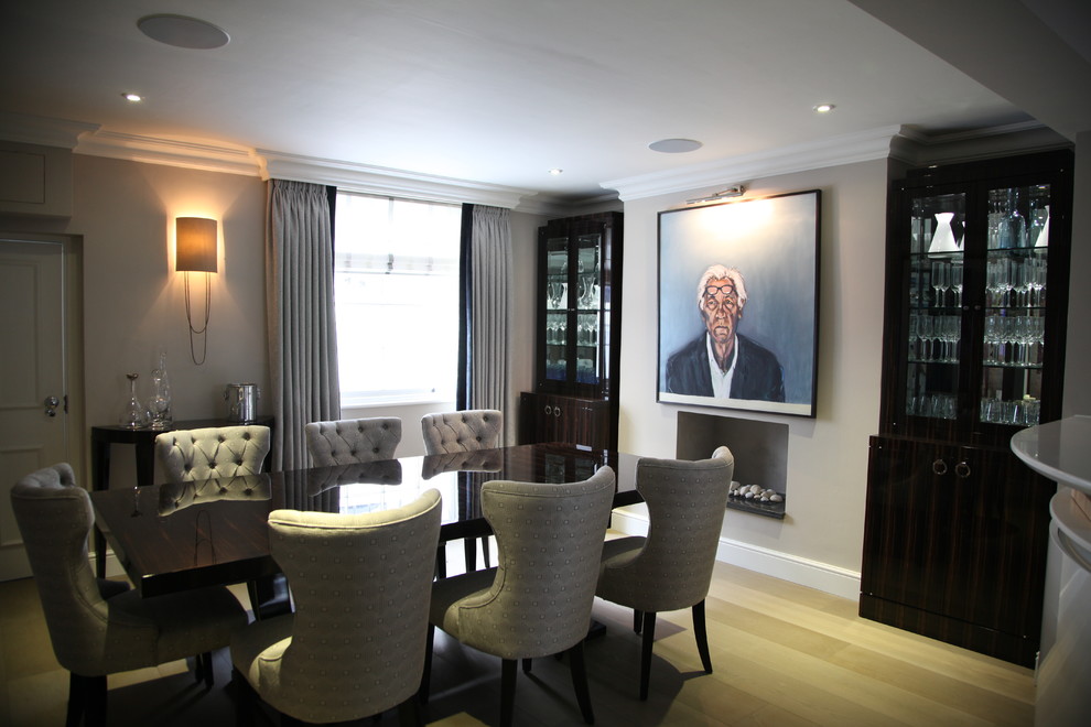 This is an example of a contemporary dining room in London with beige walls.