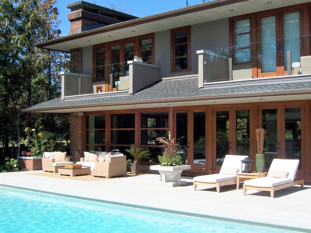 Photo of a large contemporary backyard patio in Vancouver with a fire feature, concrete slab and a roof extension.