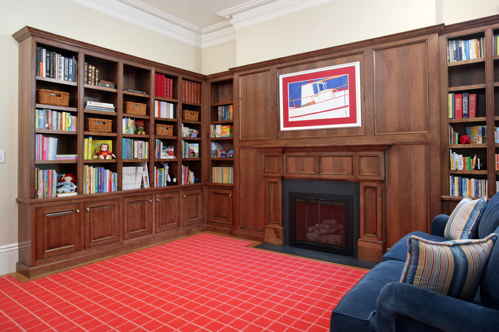 Inspiration for a large traditional home office in Boston with beige walls, carpet, red floor and a library.