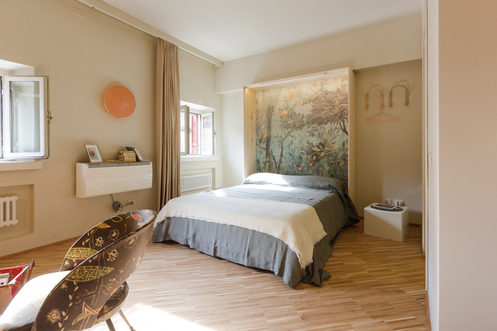 Photo of a large contemporary master bedroom in Rome with beige walls and medium hardwood floors.
