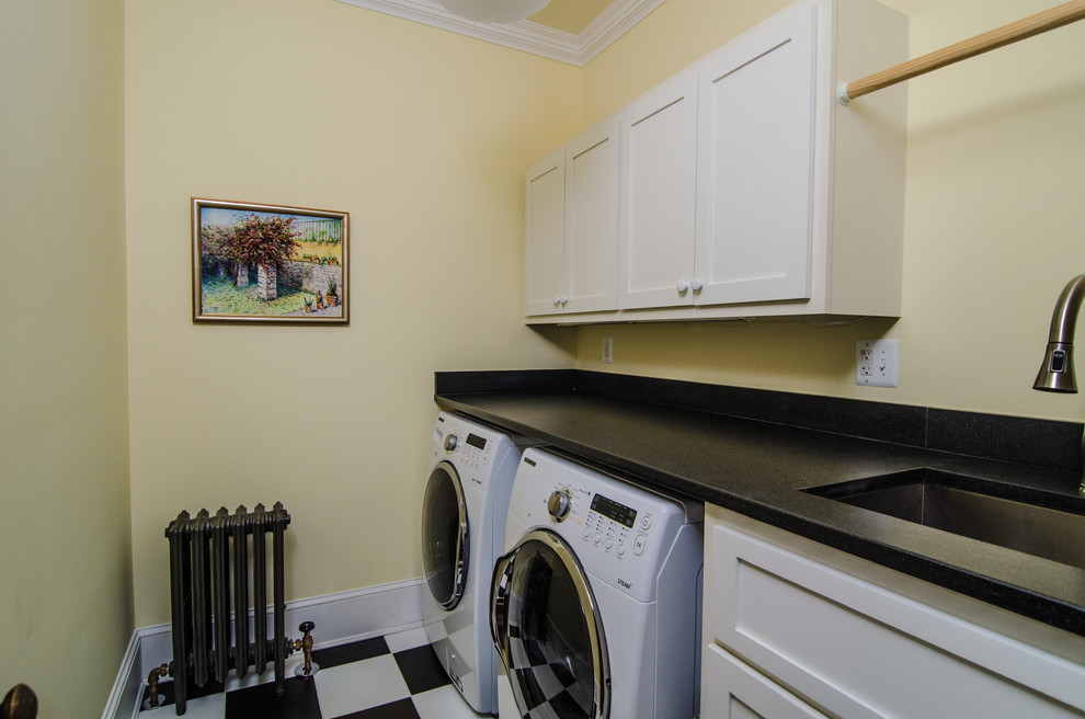 Inspiration for a traditional laundry room in DC Metro with black benchtop.
