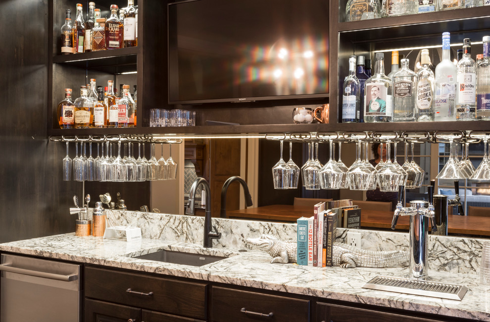 This is an example of an expansive transitional u-shaped wet bar in Portland with an undermount sink, beaded inset cabinets, dark wood cabinets, quartz benchtops, mirror splashback, medium hardwood floors, brown floor and multi-coloured benchtop.