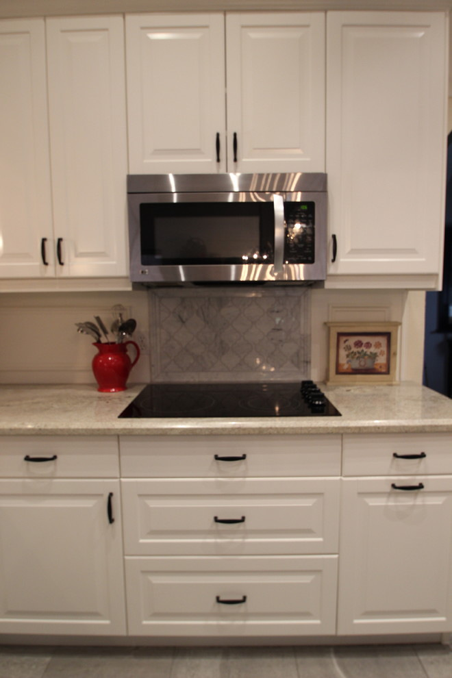 Enclosed kitchen - mid-sized transitional u-shaped ceramic tile enclosed kitchen idea in Phoenix with a double-bowl sink, raised-panel cabinets, white cabinets, marble countertops, gray backsplash, ceramic backsplash, stainless steel appliances and an island