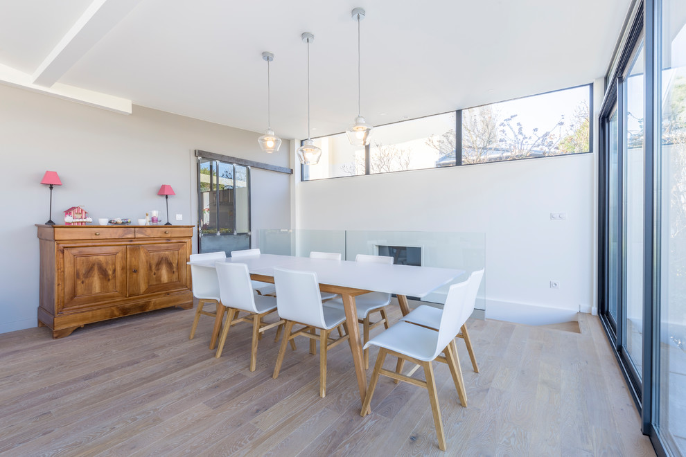 Photo of a large contemporary dining room in Lyon with light hardwood floors and beige floor.