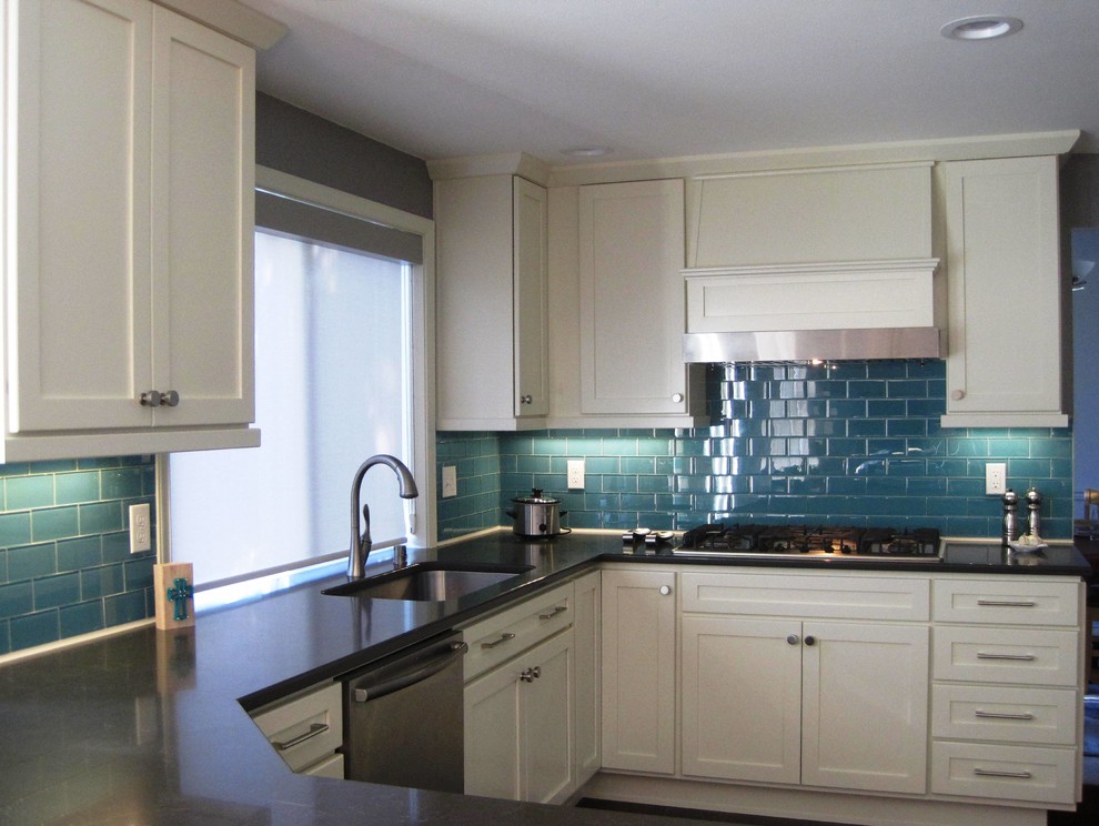 Inspiration for a mid-sized transitional u-shaped dark wood floor open concept kitchen remodel in Seattle with an undermount sink, shaker cabinets, white cabinets, quartz countertops, blue backsplash, glass tile backsplash, stainless steel appliances and a peninsula