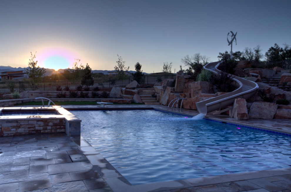 Inspiration for a large backyard rectangular water slide remodel in Denver