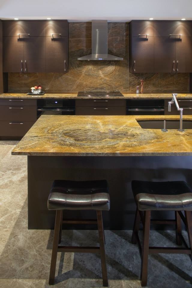 Inspiration for an expansive contemporary u-shaped eat-in kitchen in Detroit with an undermount sink, flat-panel cabinets, brown cabinets, granite benchtops, brown splashback, stone slab splashback, panelled appliances, travertine floors and with island.