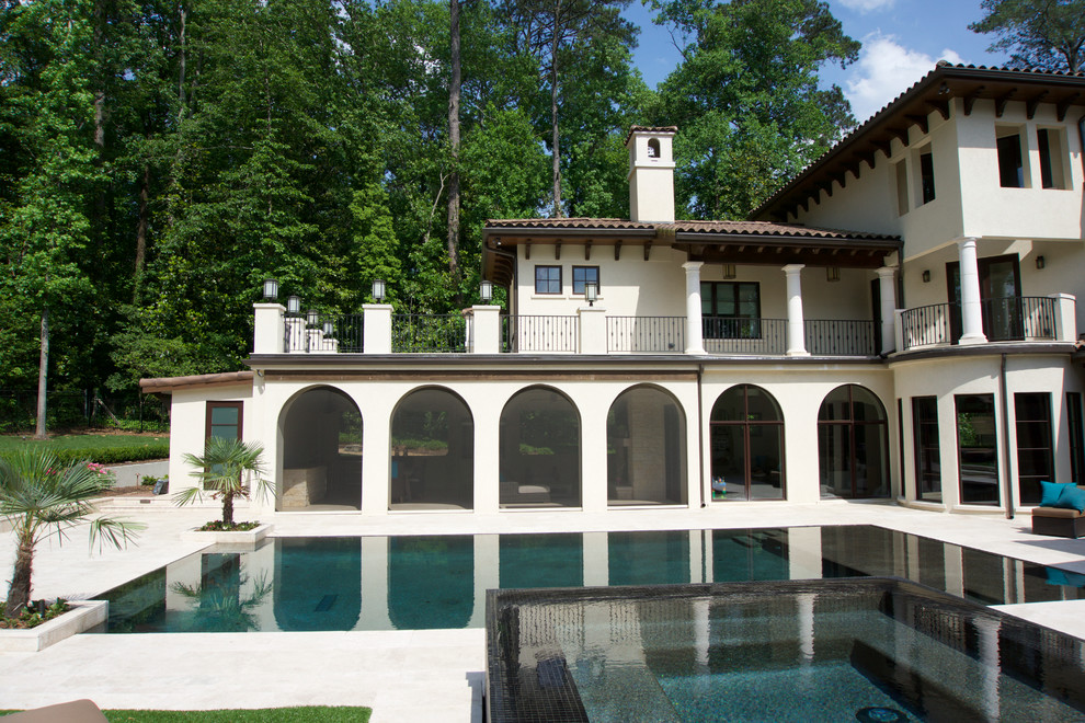 Expansive mediterranean backyard screened-in verandah in Atlanta with natural stone pavers.