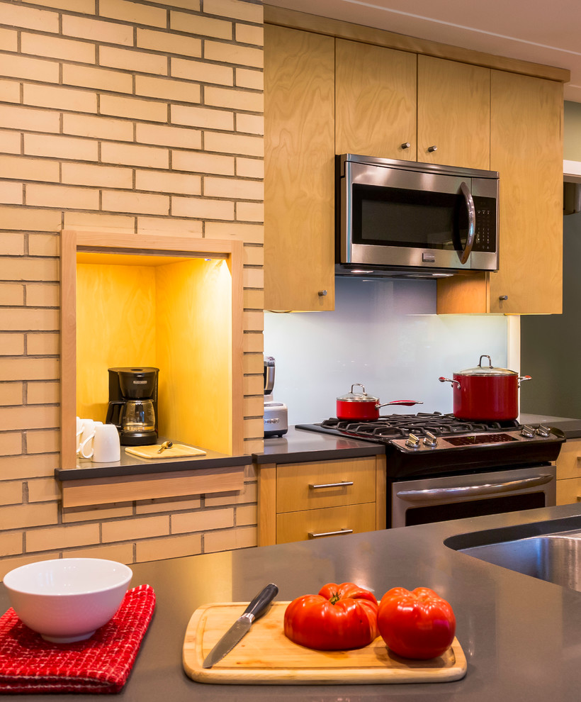 This is an example of a mid-sized midcentury galley separate kitchen in Minneapolis with an undermount sink, flat-panel cabinets, medium wood cabinets, quartz benchtops, blue splashback, glass sheet splashback, stainless steel appliances, dark hardwood floors, with island and brown floor.