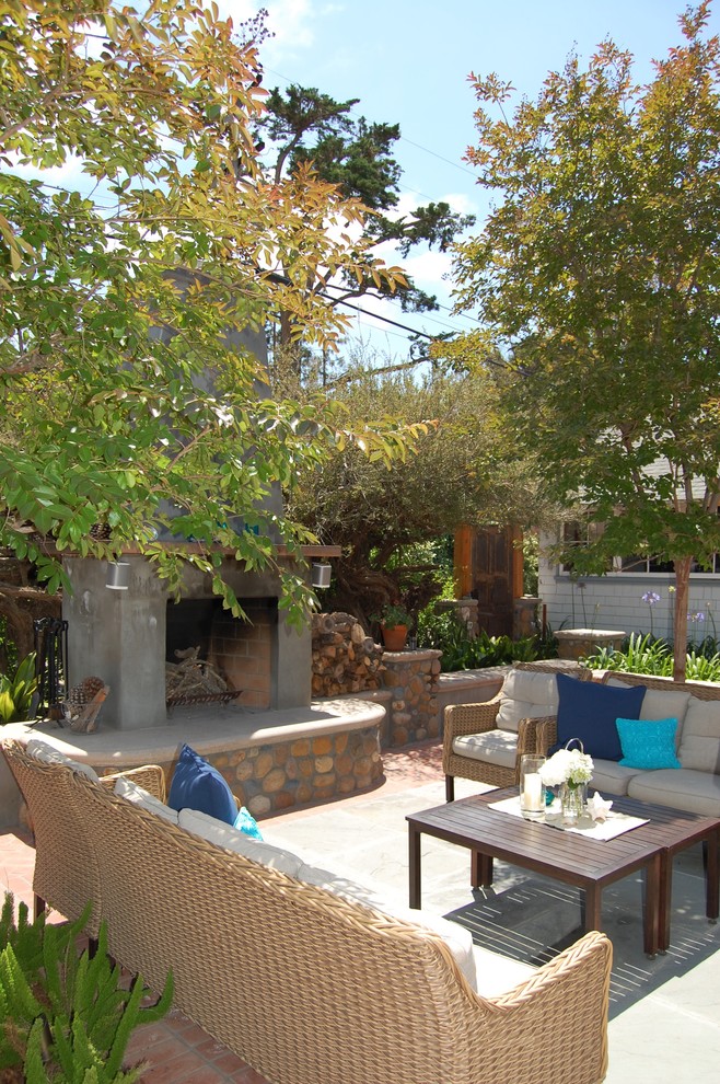 Large beach style backyard concrete paver patio photo in San Diego with a fire pit and no cover