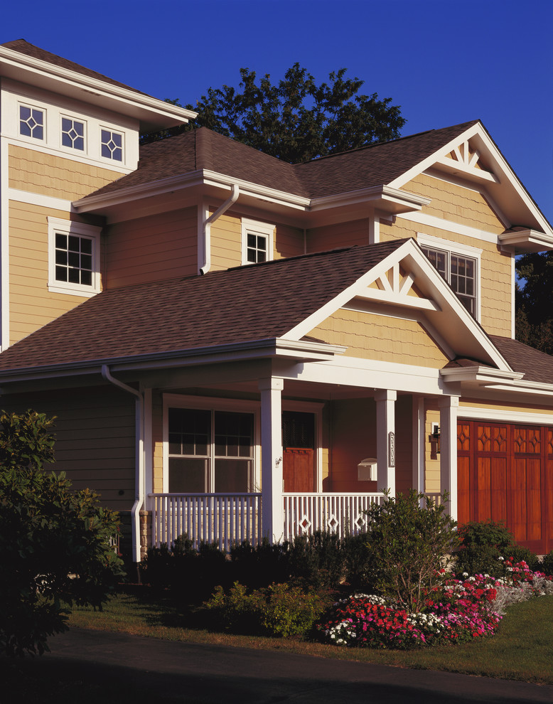 Photo of a mid-sized traditional two-storey brown house exterior in Chicago with concrete fiberboard siding, a gable roof, a shingle roof, a brown roof and shingle siding.