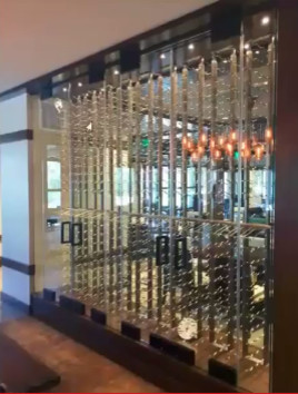 Small modern wine cellar in Orange County with display racks.