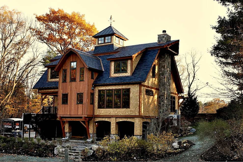 Design ideas for an eclectic two-storey brown exterior in Boston with a gambrel roof.