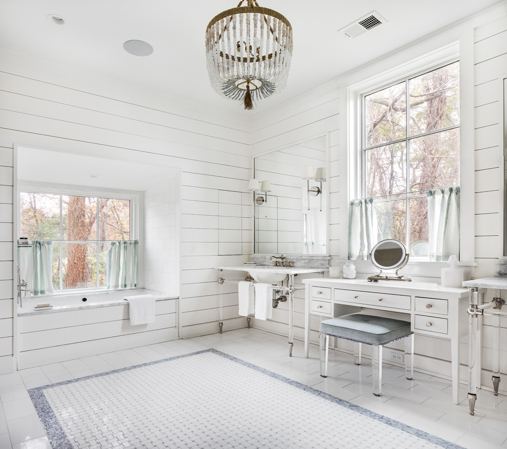 This is an example of a country master bathroom in Nashville with white cabinets, an undermount tub, white walls, a console sink, multi-coloured floor and flat-panel cabinets.