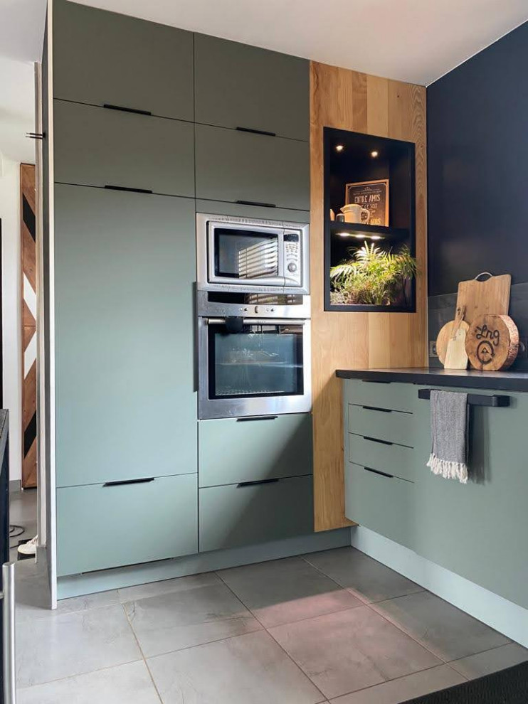Inspiration for a mid-sized modern u-shaped gray floor eat-in kitchen remodel in Other with an undermount sink, beaded inset cabinets, green cabinets, concrete countertops, black backsplash, stone slab backsplash, stainless steel appliances, no island and black countertops