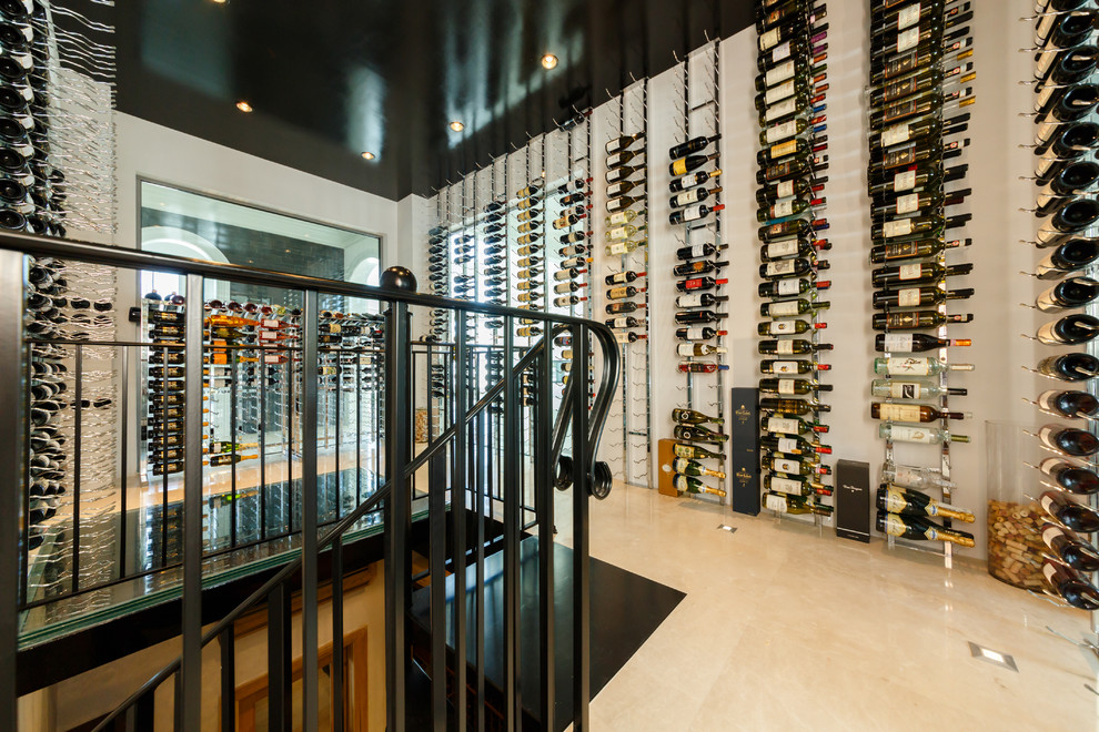 Wine cellar - huge modern marble floor wine cellar idea in New York with display racks