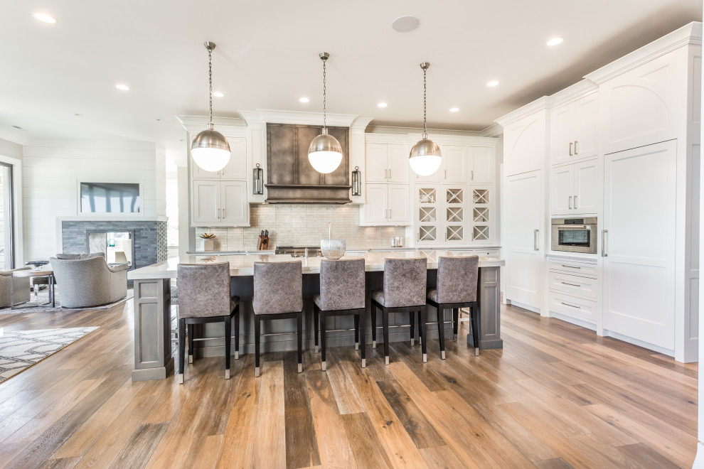 Inspiration for a transitional l-shaped kitchen remodel with flat-panel cabinets and an island