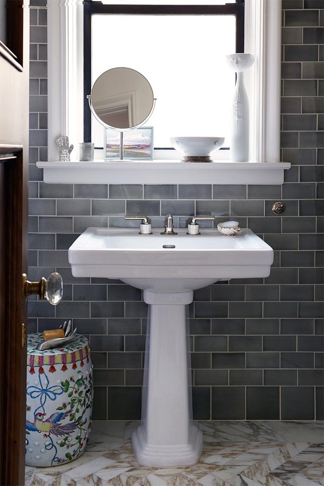Example of a mid-sized transitional master ceramic tile and gray tile marble floor bathroom design in New York with a pedestal sink and white walls