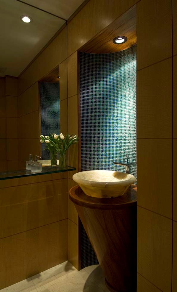 Photo of a small contemporary powder room in Hawaii with flat-panel cabinets, medium wood cabinets, blue tile, green tile, mosaic tile, brown walls, ceramic floors, a vessel sink, wood benchtops, beige floor and brown benchtops.