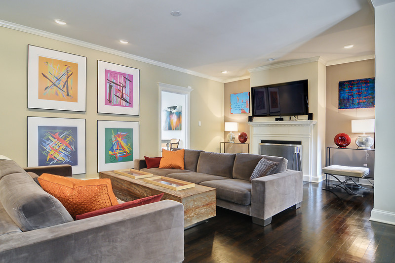 Photo of a mid-sized contemporary formal enclosed living room in Boston with multi-coloured walls, dark hardwood floors, a standard fireplace, a concrete fireplace surround and a wall-mounted tv.