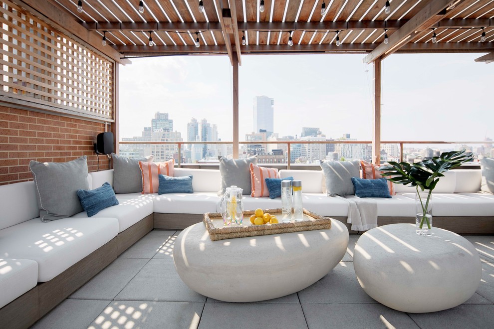This is an example of a contemporary rooftop and rooftop deck in New York with a pergola.