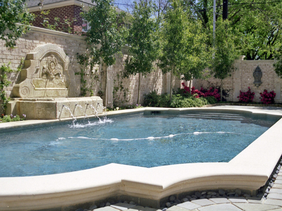 Transitional backyard pool in Dallas with natural stone pavers.