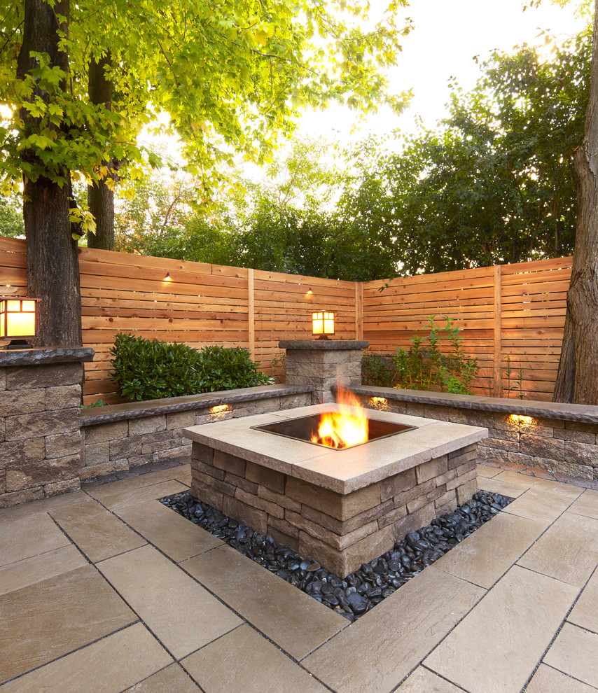 Design ideas for a large contemporary backyard garden in New York with a fire feature and natural stone pavers.