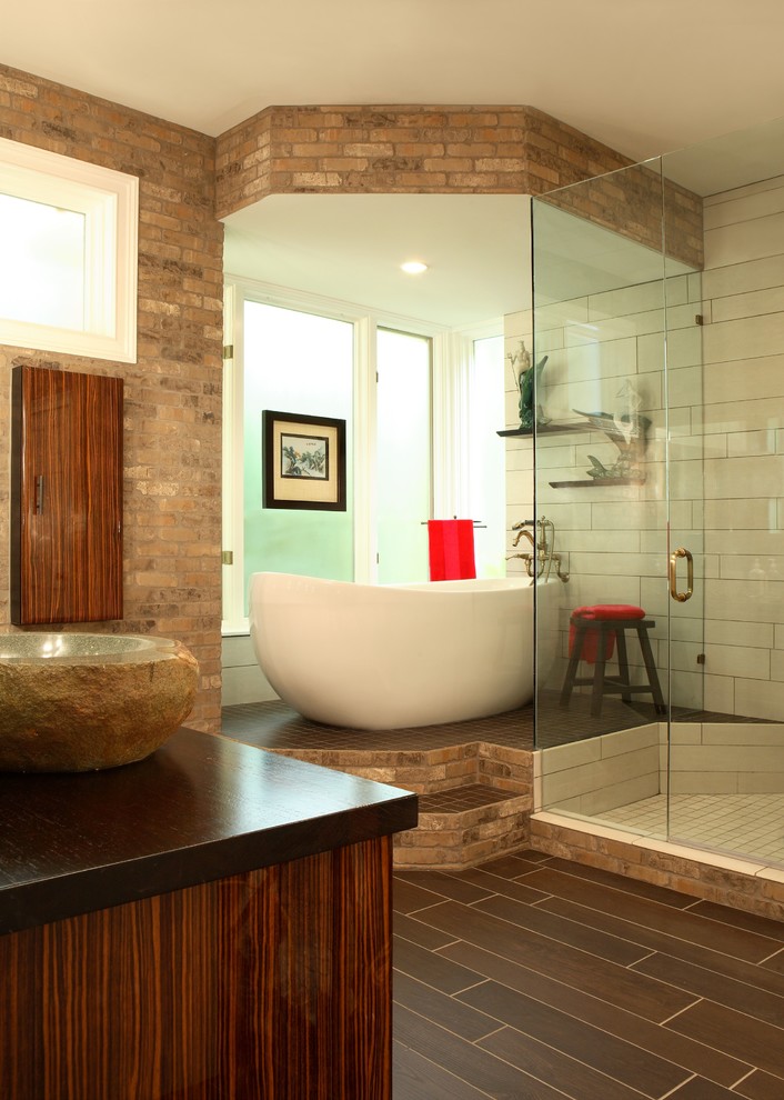 Design ideas for a large modern master bathroom in Atlanta with a vessel sink, flat-panel cabinets, medium wood cabinets, wood benchtops, a freestanding tub, a corner shower, a two-piece toilet, brown tile, porcelain tile, porcelain floors, brown walls, brown floor and a hinged shower door.