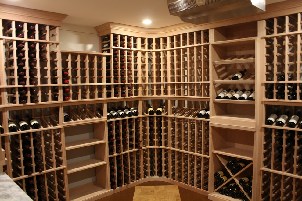 This is an example of a mid-sized transitional wine cellar in Boston with cork floors and storage racks.