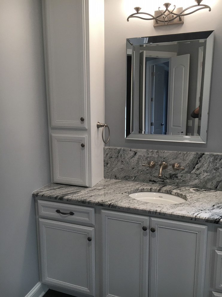 Design ideas for a mid-sized traditional master bathroom in Other with recessed-panel cabinets, white cabinets, a corner shower, a two-piece toilet, multi-coloured tile, grey walls, dark hardwood floors, an undermount sink, granite benchtops and an open shower.