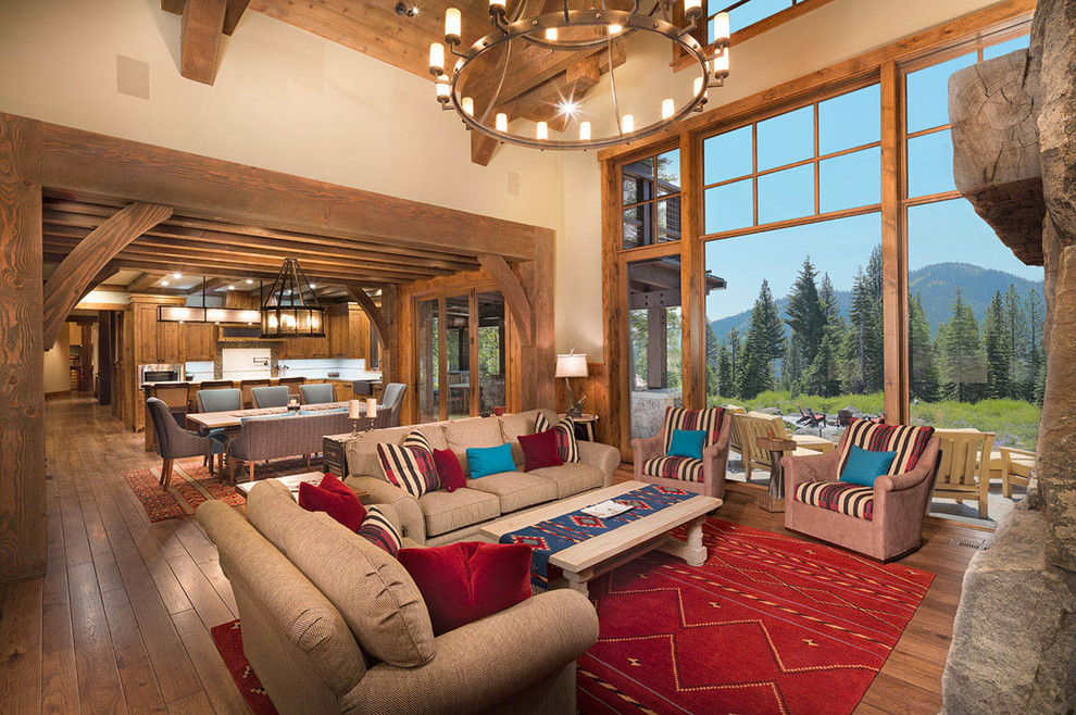 Large mountain style open concept and formal dark wood floor living room photo in Other with beige walls, a standard fireplace, a stone fireplace and no tv