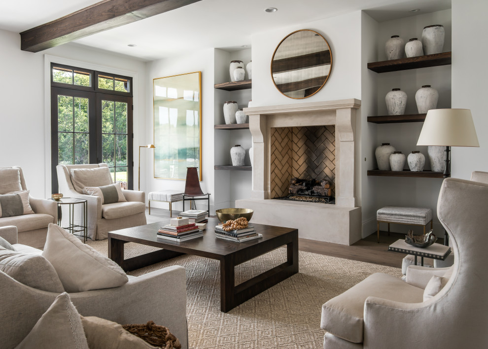 Inspiration for a large transitional open concept and formal medium tone wood floor and brown floor living room remodel in Nashville with white walls, a standard fireplace, a stone fireplace and no tv