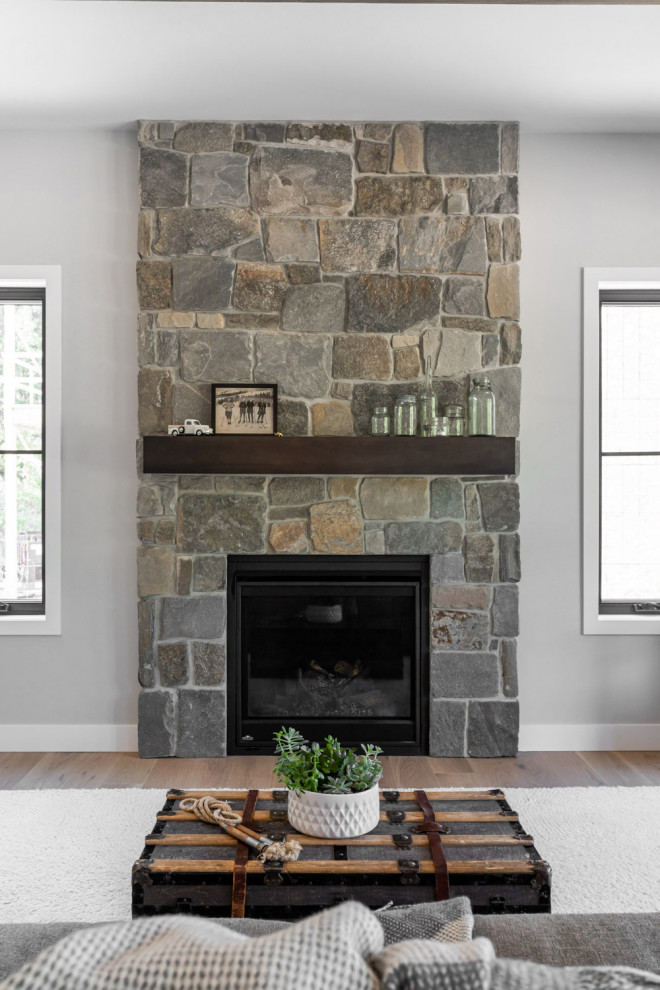 Inspiration for a mid-sized transitional single-wall light wood floor, brown floor and exposed beam eat-in kitchen remodel with an undermount sink, shaker cabinets, gray cabinets, quartzite countertops, white backsplash, subway tile backsplash, stainless steel appliances, an island and multicolored countertops