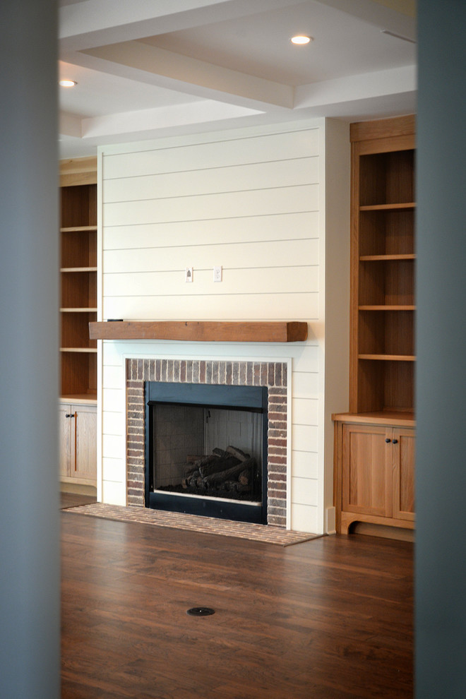 Inspiration for a large country open concept dark wood floor living room remodel in Jacksonville with white walls, a standard fireplace and a brick fireplace