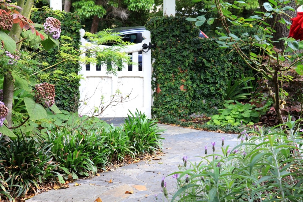 Traditional front yard garden in Melbourne with a garden path.