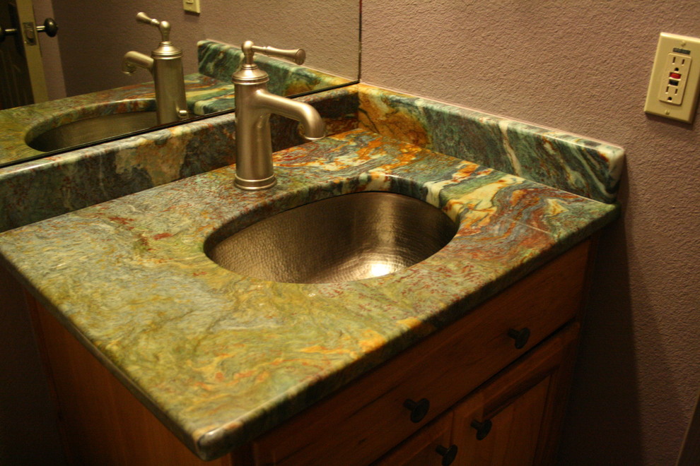 Small transitional porcelain tile home design photo in Austin with an undermount sink, raised-panel cabinets, light wood cabinets, granite countertops and beige walls