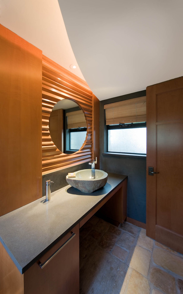 This is an example of a contemporary powder room in Milwaukee with a vessel sink.