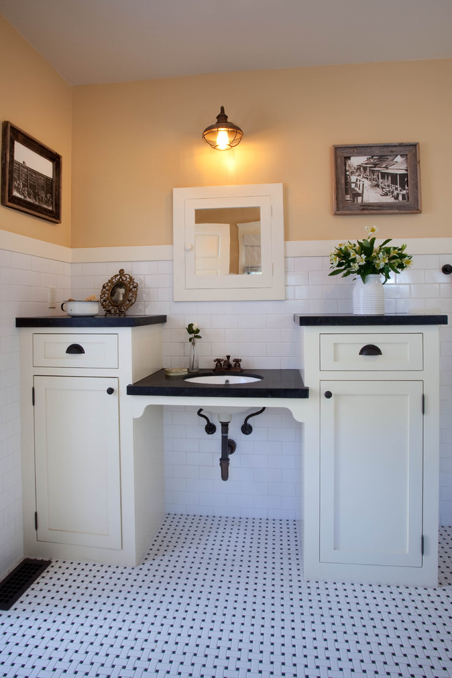 Arts and crafts 3/4 bathroom in San Diego with shaker cabinets, white cabinets, white tile, subway tile, yellow walls, mosaic tile floors, an undermount sink and soapstone benchtops.