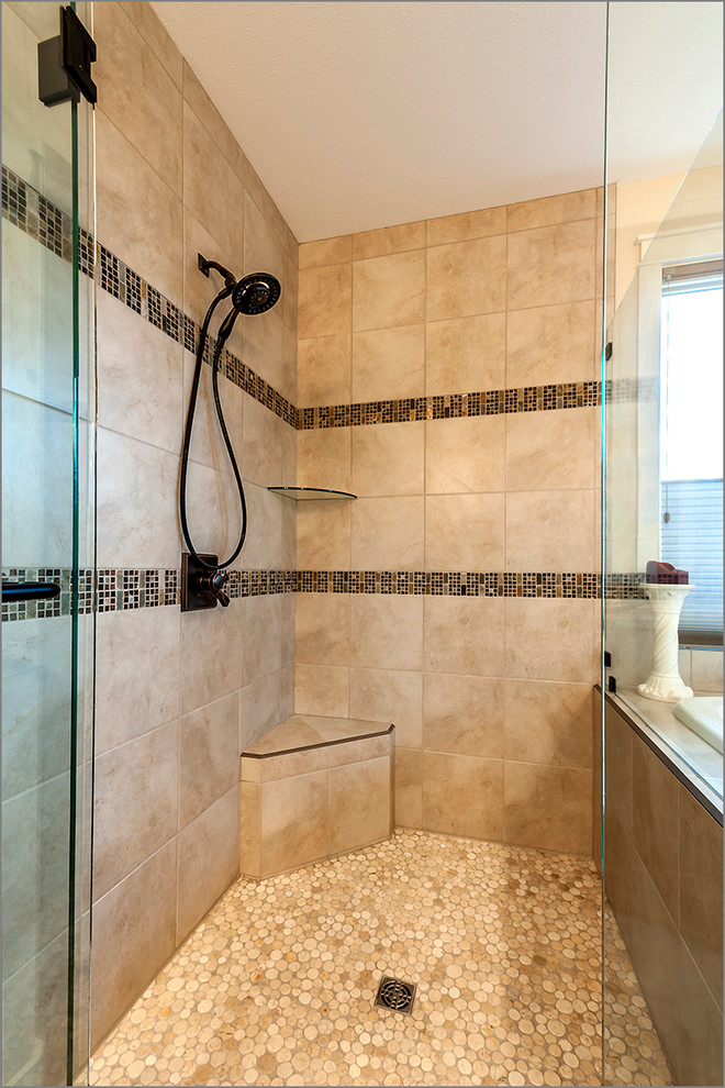 Inspiration for an expansive contemporary master bathroom in Calgary with a drop-in sink, recessed-panel cabinets, medium wood cabinets, solid surface benchtops, a curbless shower, multi-coloured tile, stone tile, beige walls and ceramic floors.