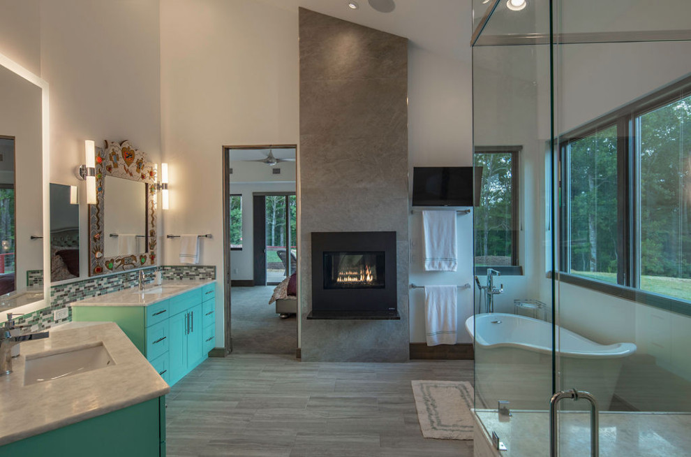 Contemporary master bathroom in Other with flat-panel cabinets, green cabinets, a freestanding tub, a curbless shower, a two-piece toilet, multi-coloured tile, glass tile, white walls, porcelain floors, an undermount sink, onyx benchtops, grey floor and white benchtops.